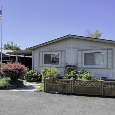 home exterior with plants and fence