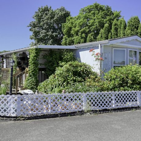 home exterior with plants and fence